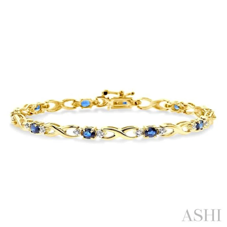 4x3mm Oval Cut Sapphire and 1/10 Ctw Single Cut Diamond Bracelet in 10K Yellow Gold