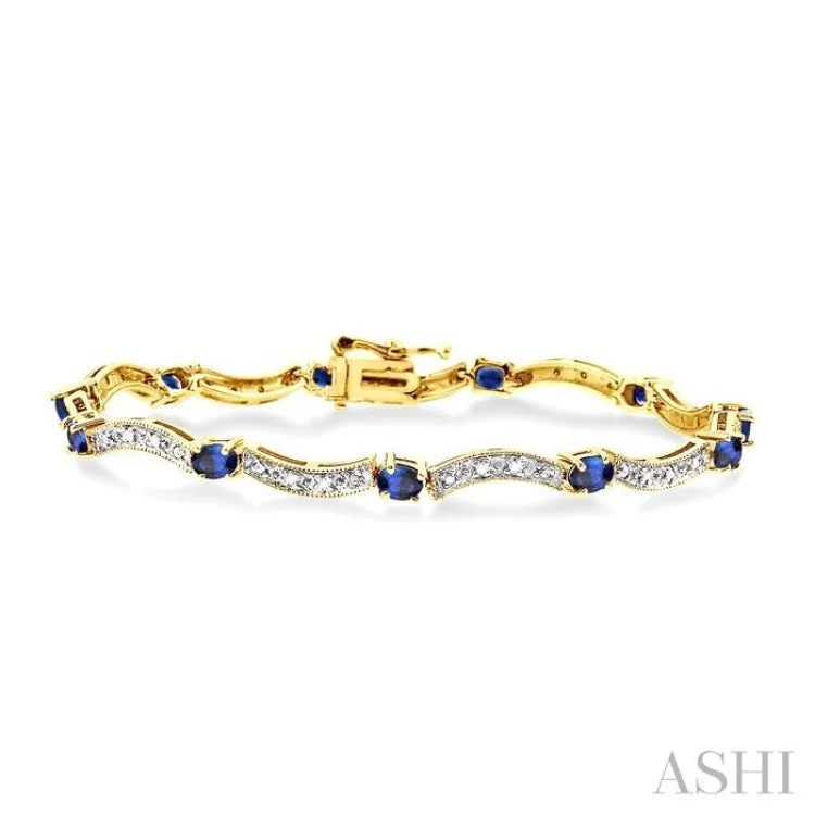 4x3mm Oval Cut Sapphire and 1/10 Ctw Single Cut Diamond Tennis Bracelet in 14K Yellow Gold